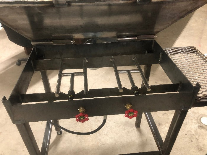 Burners under custom propane flat top griddle grill with side table and utensil hanger designed and built by HL Guest Handmade